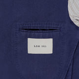 Close-up of the inside pocket of L.B.M.'s Wool Garment Dyed Sportcoat. The white label shows the brand name, and the partial lining is white with thin gray stripes.