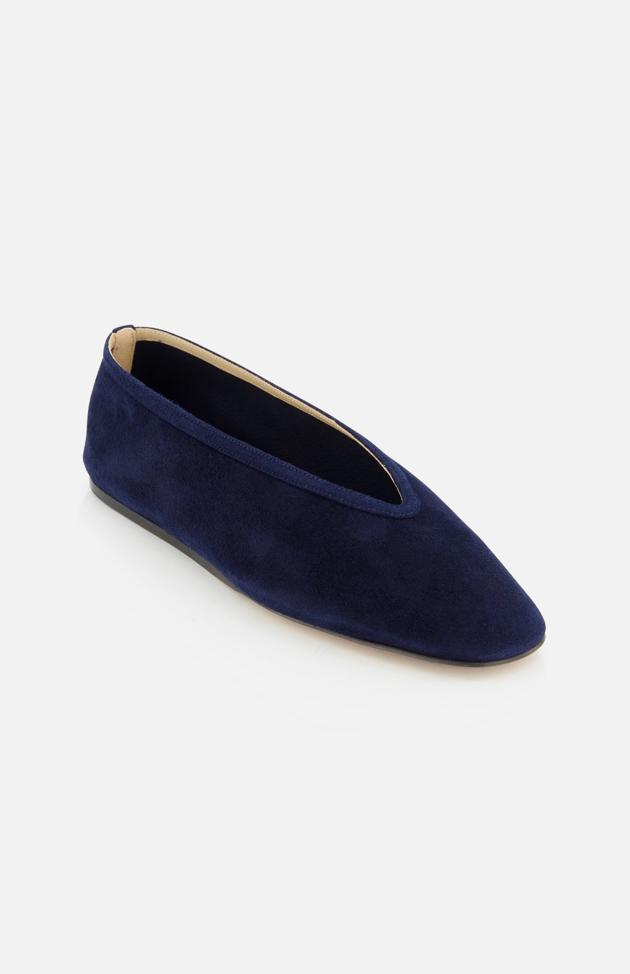 The Luna Suede Slipper Flat by LE MONDE BERYL is a dark blue Italian-made suede slip-on with a slightly pointed toe, low-cut vamp, and beige interior, shown against a white background.