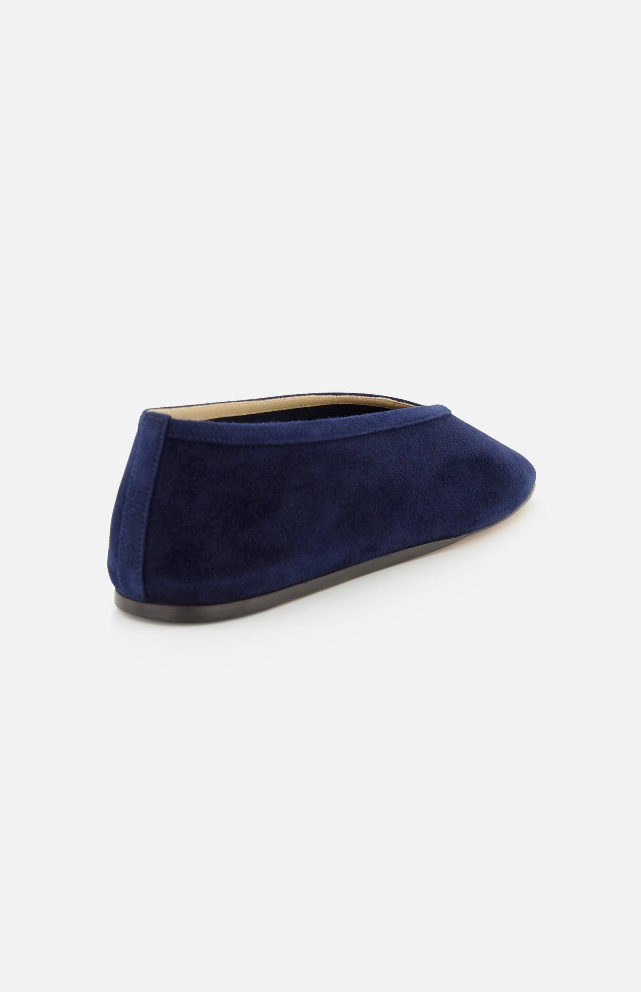 The Luna Suede Slipper Flat by LE MONDE BERYL is shown from the back in dark blue suede, featuring a rounded toe and low heel. Made in Italy, it stands against a plain light background.