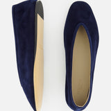 The Luna Suede Slipper Flat by LE MONDE BERYL is a pair of dark blue suede slip-on ballet flats with tan soles, shown from side and top views on a white background. Expertly crafted in Italy.