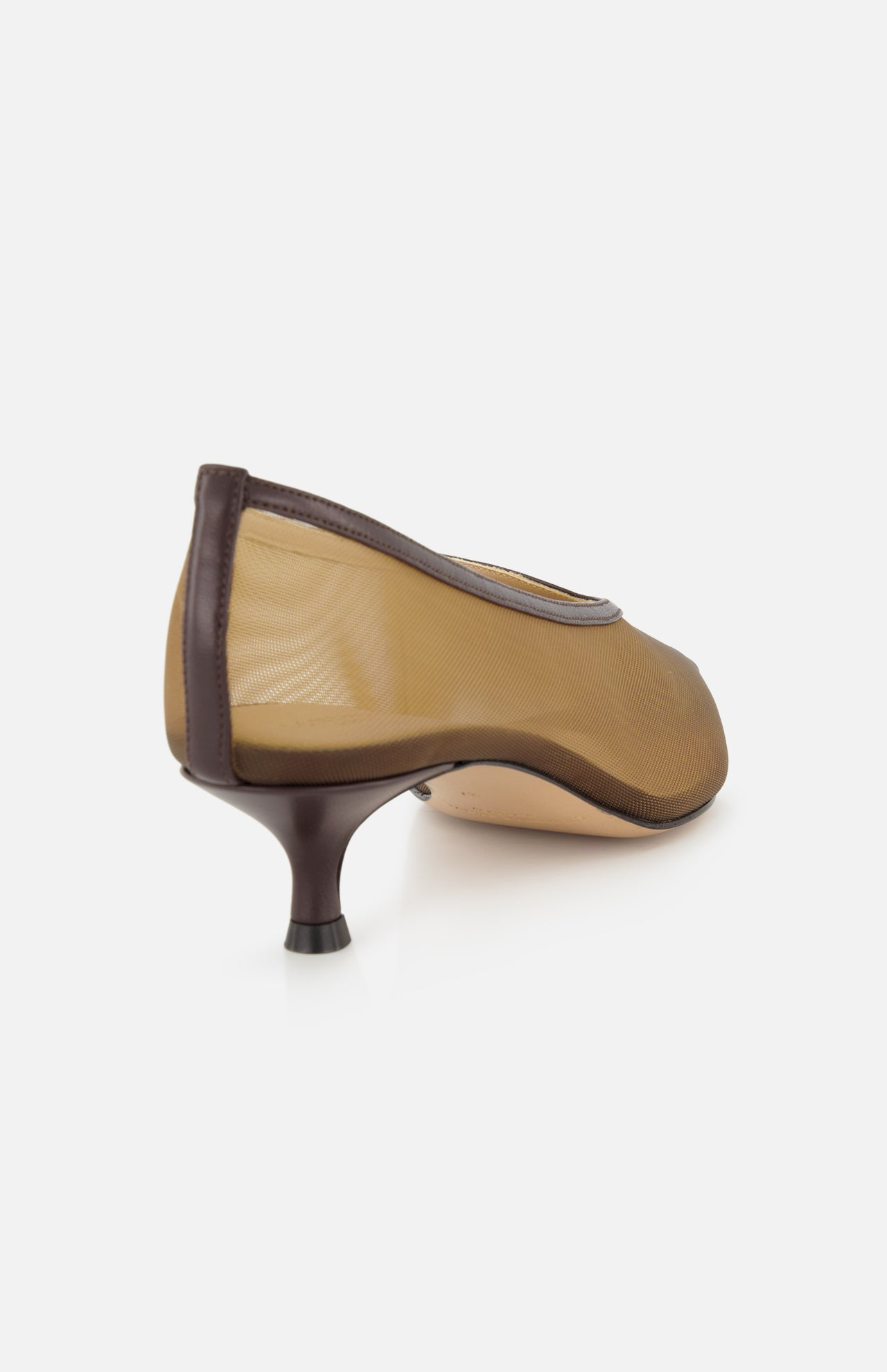 A close-up rear view of LE MONDE BERYL’s Babouche Mesh Kitten Heel showcases its sheer beige mesh upper, brown trim, pointed toe, and short dark brown kitten heel on a plain white background.
