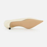 The LE MONDE BERYL Babouche Leather Kitten Heel, featuring a white leather pointed toe and smooth beige sole, lies on its side to showcase its elegant silhouette against a plain white background.