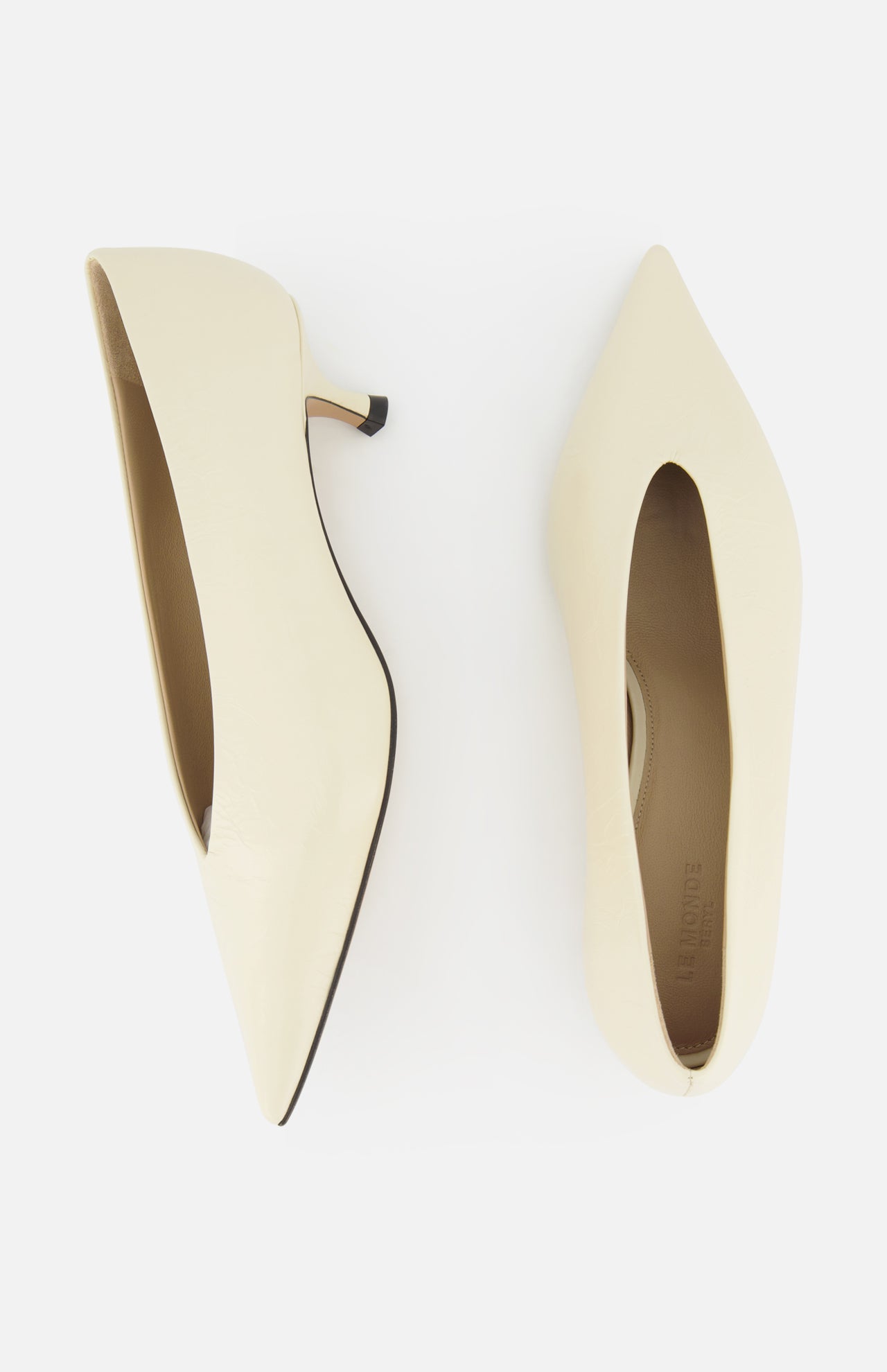 A pair of LE MONDE BERYL Babouche Leather Kitten Heels in off-white, shown from above on a white background—one shoe displays the side profile, the other shows the top view.
