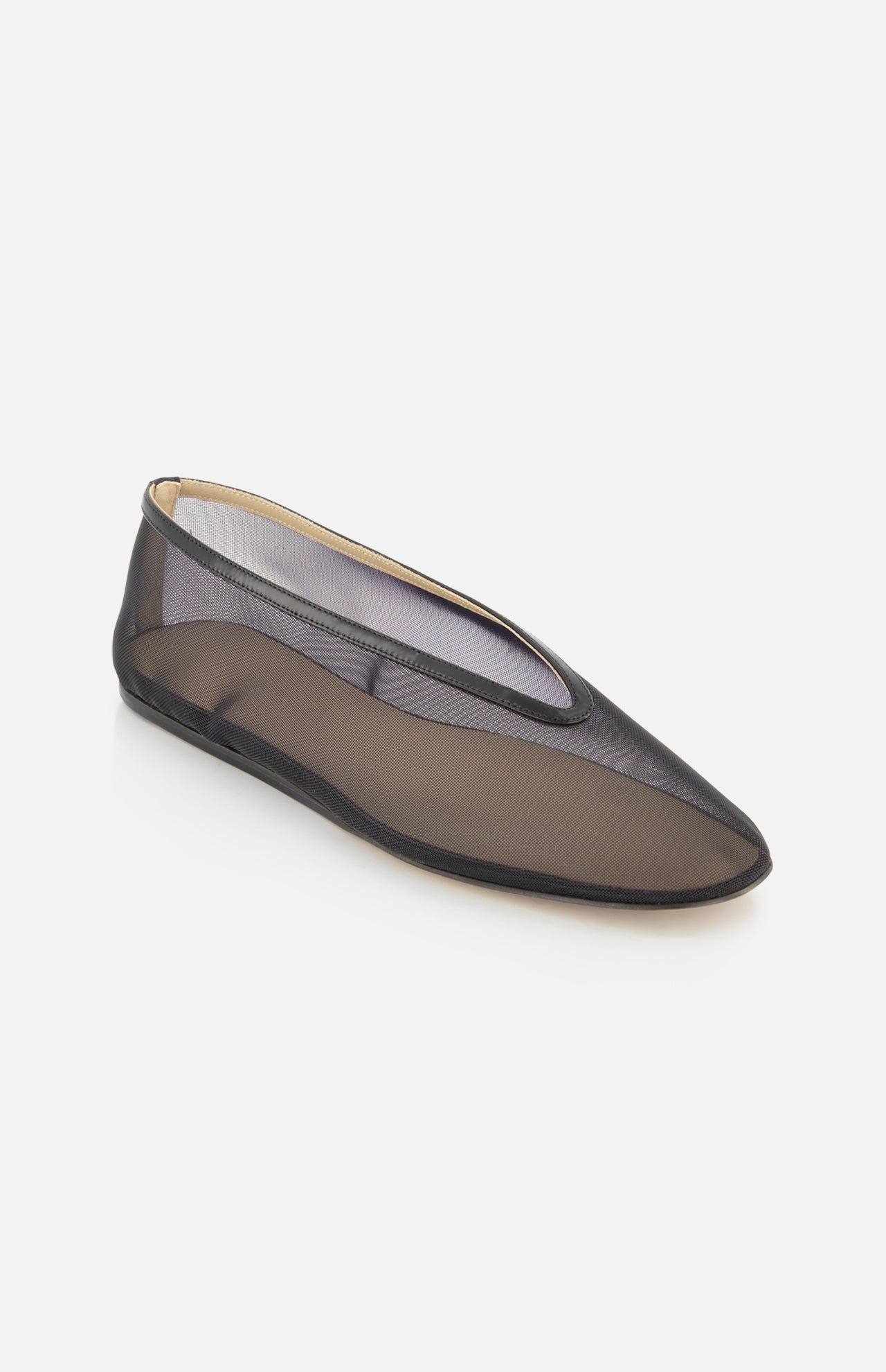 The Luna Mesh Slipper by LE MONDE BERYL is a single black mesh flat with a rounded toe, thin black sole, and cushioned calf leather insole. Semi-transparent and handcrafted in Italy, it's pictured on a white background.
