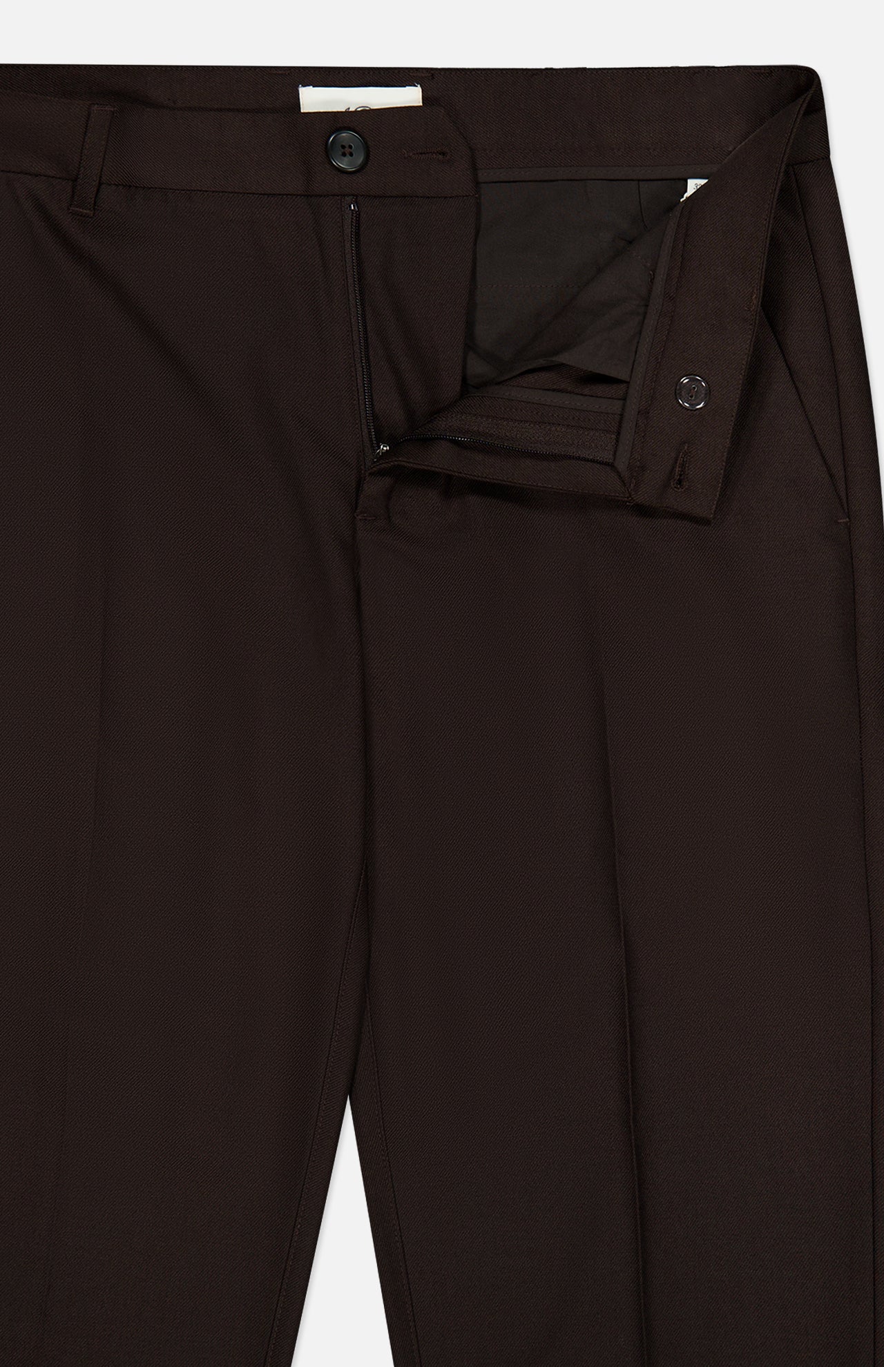 A close-up of the Brushed Twill Regular Suit Pants by LES DEUX in dark brown, featuring fastened top button with unzipped fly and open inner clasp, highlighting the brushed twill fabric, waistband, and part of the pocket.
