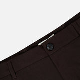 Close-up of the waistband of the LES DEUX Brushed Twill Regular Suit Pants in dark brown, highlighting the brushed twill fabric, black button, belt loops, and part of the zipper fly against a plain light background.