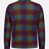 A wool zipper coach jacket by LES DEUX, featuring a large check pattern in purple, green, blue, and yellow—reminiscent of classic autumn colors—displayed from the back against a plain light gray background. Perfect for layering within preppy urban wardrobes.