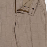 Close-up of LES DEUX Como Reg Houndstooth Suit Pants in light brown, straight fit, with open fly showing the interior waistband and button closure. The fabric displays a subtle houndstooth pattern.
