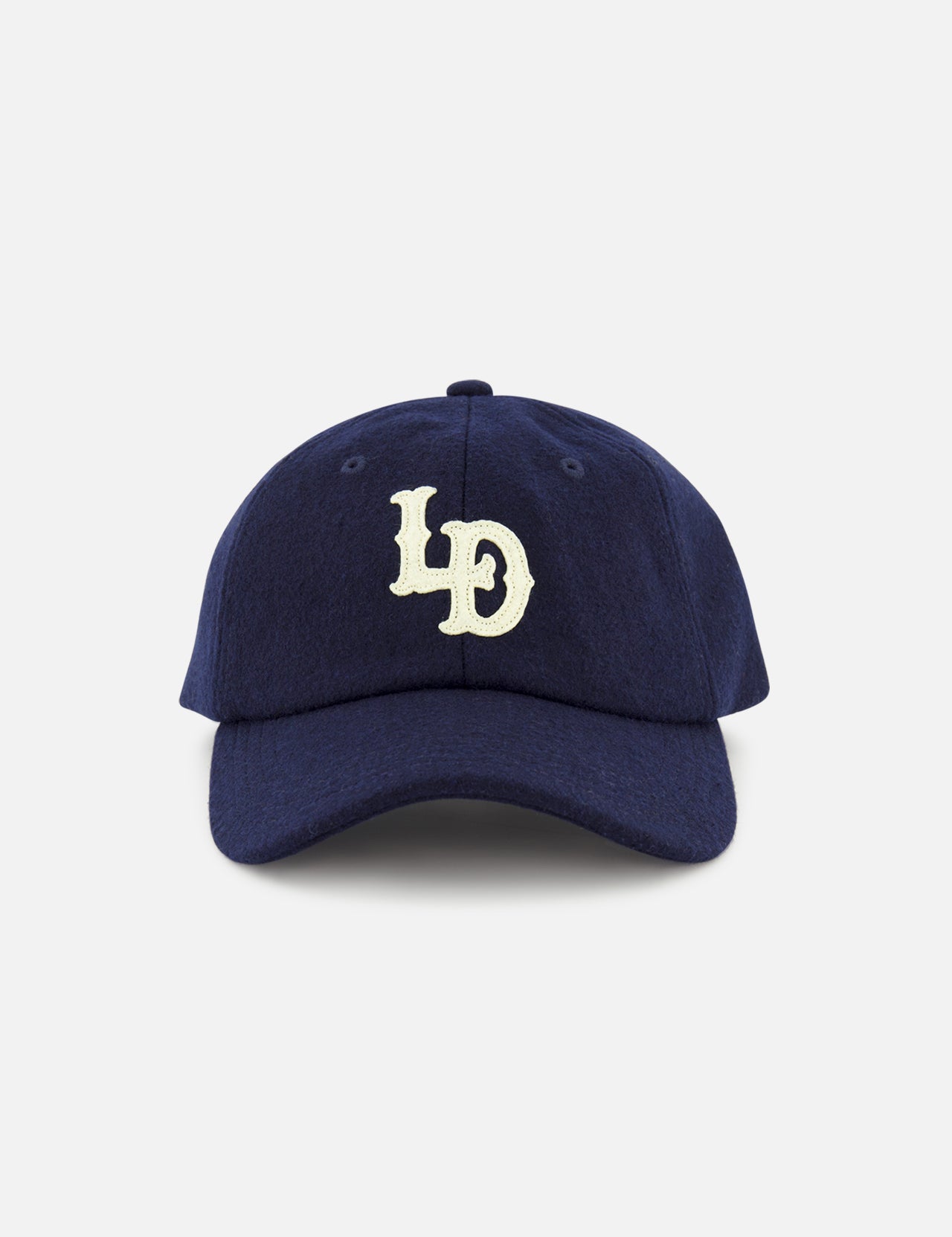 A navy blue LES DEUX Felt Logo Dad Cap with white “LD” letters embroidered on the front, displayed against a plain white background.