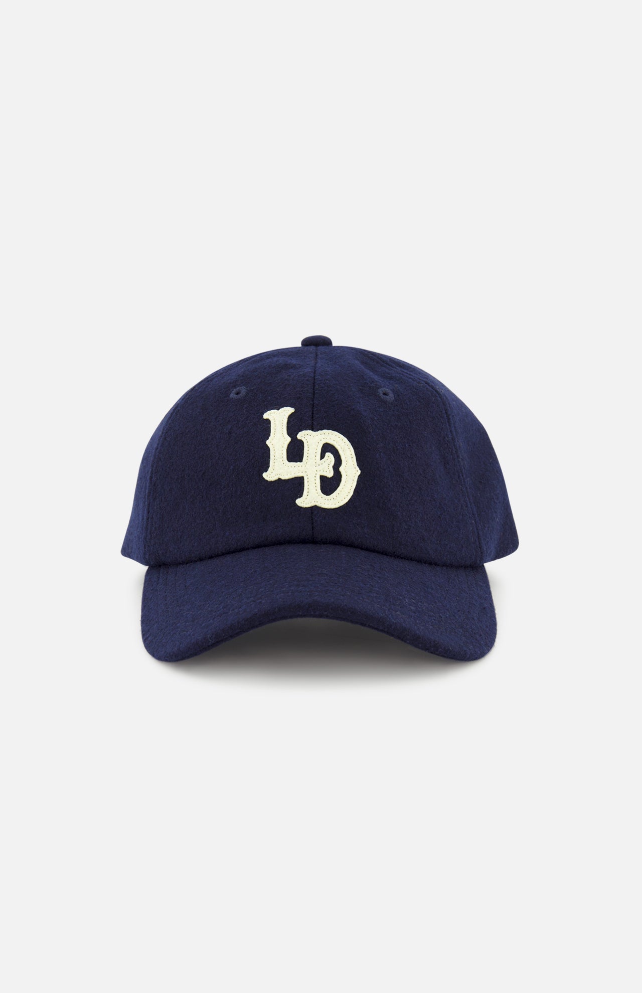 A navy blue LES DEUX Felt Logo Dad Cap with white “LD” letters embroidered on the front, displayed against a plain white background.
