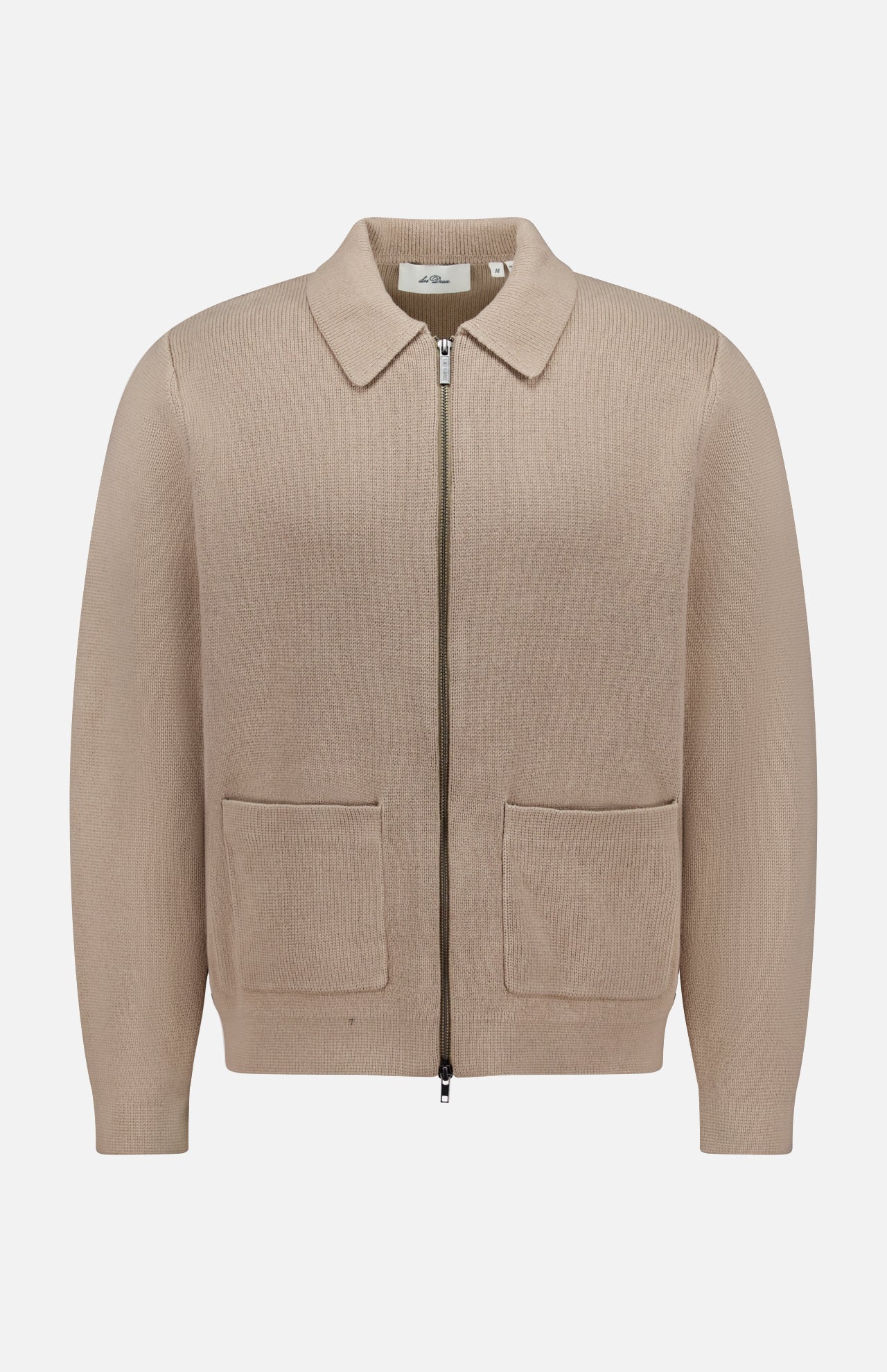 The LES DEUX Fischer Cotton Milano Zip Overshirt is a beige, collared zip-up with two front pockets, made from durable structured knit, shown against a plain white background.
