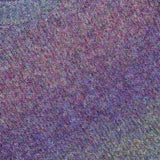 Close-up of the LES DEUX Gradient Roundneck Knit Sweater, showcasing its textured knit and gradient-dyed shades of spiced plum, green, and blue. A white clothing tag with text is visible near the collar.