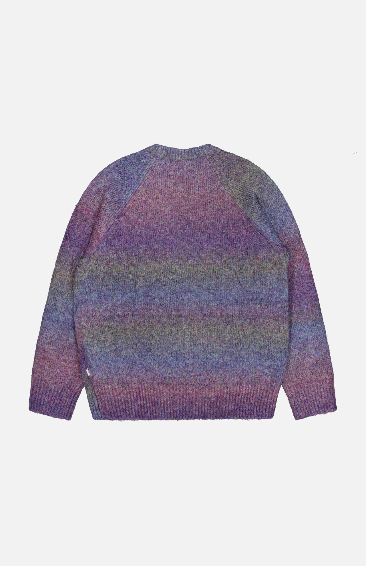 The LES DEUX Gradient Roundneck Knit Sweater, featuring long sleeves and a crew neckline, displays a multicolored gradient dyed pattern in shades of spiced plum, blue, and green, and is shown laid flat on a white background.