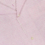 Close-up of the LES DEUX Lukas Stripe Cotton Linen Short Sleeve Shirt in pink with white and light pink stripes, two buttons in view, and a partial white LES DEUX label at the top left.