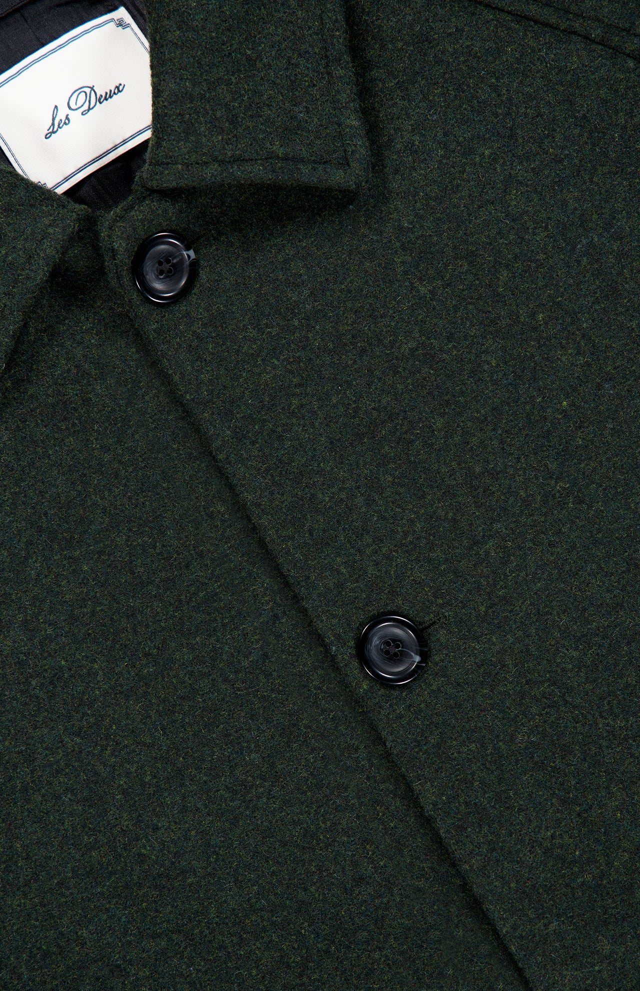Close-up of the Wool-blend Coat in dark green, featuring black buttons and a visible white LES DEUX label inside the collar.