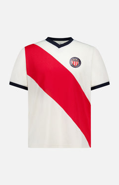The LES DEUX USA Football Jersey is a white short-sleeve shirt with a bold red diagonal stripe, blue V-neck collar and sleeve trim, plus a club crest with red and white stripes on the left chest.