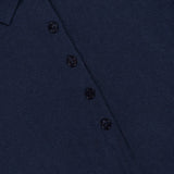 Close-up of the Anthea Twist-front Midi Dress by LISA YANG in navy, featuring refined collared detailing, a four-button front, and a visible brand label at the neckline—embodying sophisticated elegance.