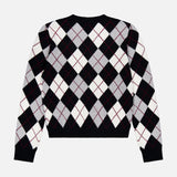 The Antoni Cashmere Argyle Sweater by LISA YANG is a luxurious, long-sleeve black sweater crafted from cashmere, showcasing a classic gray and white diamond argyle pattern with thin red lines intersecting the diamonds. The sweater is displayed laid flat on a white background.