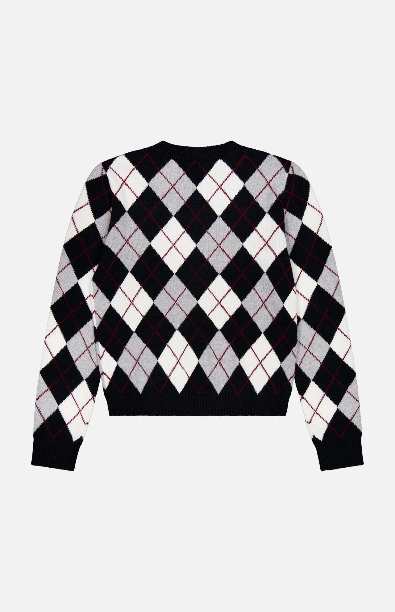 The Antoni Cashmere Argyle Sweater by LISA YANG is a luxurious, long-sleeve black sweater crafted from cashmere, showcasing a classic gray and white diamond argyle pattern with thin red lines intersecting the diamonds. The sweater is displayed laid flat on a white background.