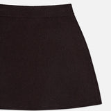 A close-up of the Clare Cashmere Mini Skirt by LISA YANG shows only the upper portion of this slow luxury brand piece, highlighting its ribbed waistband and heavy knit black cashmere against a white background.