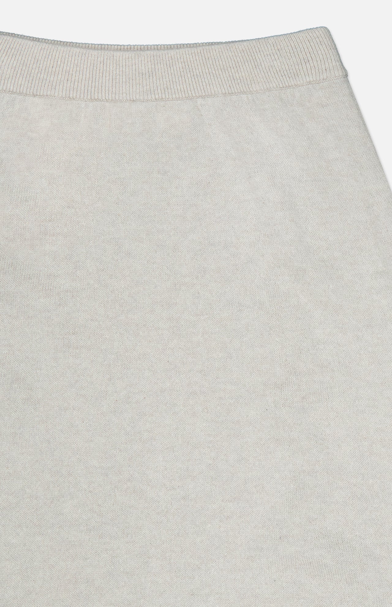 A close-up view of the light gray ribbed waistband on the soft knit fabric of the LISA YANG Dolly Cashmere Maxi Skirt, shown against a neutral background.