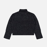 The Femi Sparkle Turtleneck Sweater by LISA YANG, in dark gray, features long sleeves and a ribbed knit design with a high neckline. Displayed flat with the back side facing up on a white background, this luxury cashmere piece delivers both comfort and style for any occasion.