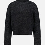 The Femi Sparkle Turtleneck Sweater by LISA YANG is a black, long-sleeve, ribbed knit cashmere sweater featuring a high neck and relaxed fit, shown against a plain white background. This luxury piece blends timeless elegance with exceptional comfort.