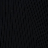Close-up of the Isabela Maxi Dress by LISA YANG, featuring black knit fabric with a raised, wavy, linear texture running diagonally across the surface.