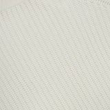 Close-up of the textured, off-white knit fabric of the Miki Cashmere Sweater. A small section of a label showing “LISA YANG,” the brand renowned for its pure cashmere pieces, appears at the top left corner.