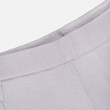 Close-up of a light gray knitted fabric featuring a ribbed waistband and decorative stitching detail. The soft, slightly textured material indicates it is part of the Olanda Cashmere Wide-leg Pant by LISA YANG.
