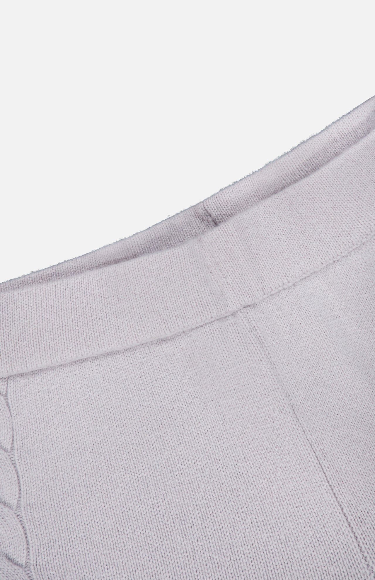 Close-up of a light gray knitted fabric featuring a ribbed waistband and decorative stitching detail. The soft, slightly textured material indicates it is part of the Olanda Cashmere Wide-leg Pant by LISA YANG.