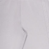 Close-up of the LISA YANG Olanda Cashmere Wide-leg Pant in light gray, highlighting the waistband, seam, and side pocket. A subtle braided knit pattern runs vertically along the side, adding understated detail to this minimalist cashmere design.