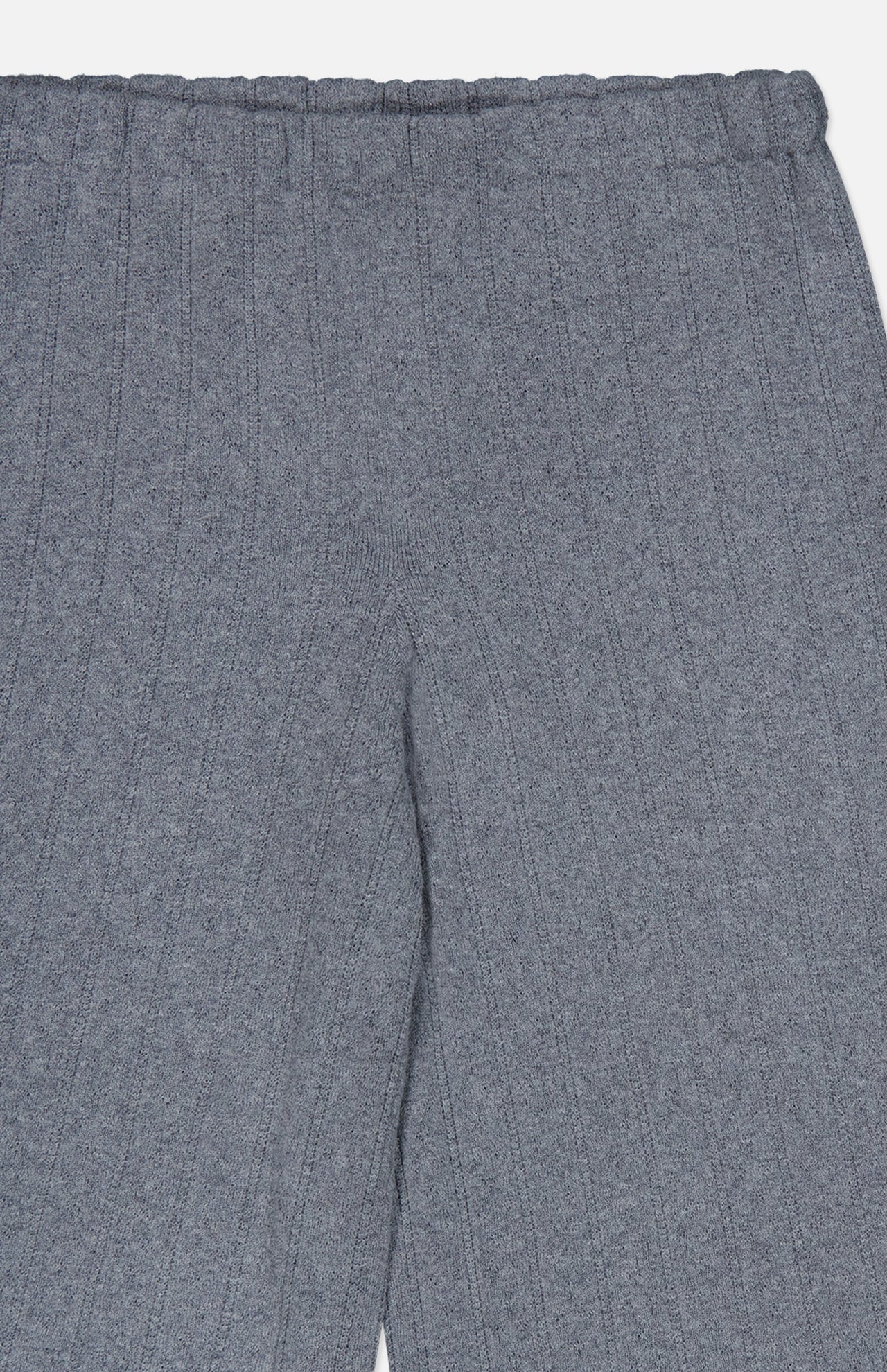 The Shannen Wide Leg Cashmere Pants by LISA YANG are shown from the waist to the upper legs. Crafted from a soft cotton-cashmere blend, these gray pants feature a vertical ribbed texture, an elastic waistband, and appear exceptionally comfortable.