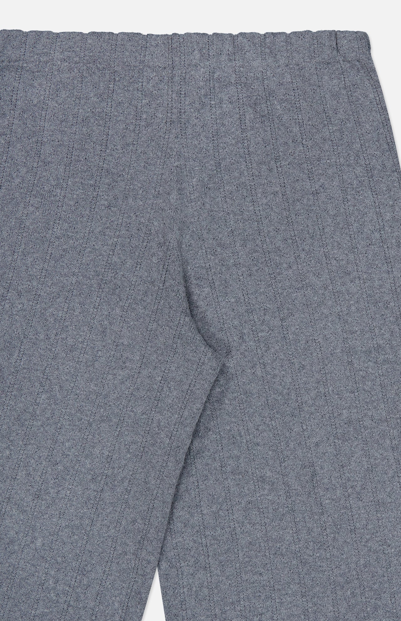 Close-up of the Shannen Wide Leg Cashmere Pants by LISA YANG in gray, highlighting the ribbed knit waistband and upper leg area with a subtle vertical striped texture.