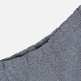 Close-up of the Shannen Wide Leg Cashmere Pants by LISA YANG, showcasing the grey, ribbed knit fabric with a visible elastic waistband crafted from a soft cotton-cashmere blend, set against a plain white background.