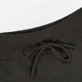 Close-up of the Sofi Cashmere Drawstring Pant by LISA YANG in black, showcasing an elastic waistband with a front drawstring bow. The texture of the cashmere fabric is visible, along with a partial pocket seam on the right side—an understated design that captures slow luxury and refined Scandinavian style.