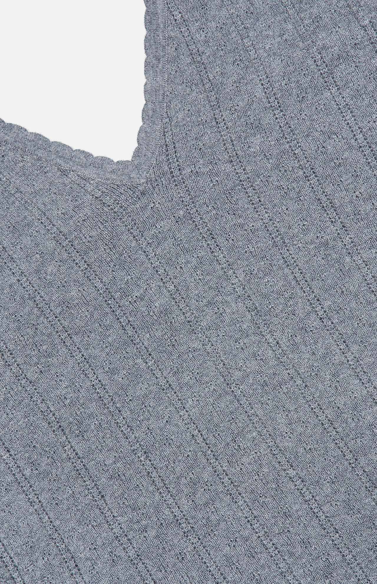 Close-up of the Suni V-neck Tank Top by LISA YANG in a gray, ribbed knit cotton cashmere fabric, featuring a V-shaped neckline and delicate scalloped trim along the edge—beautifully highlighting this refined tank top’s texture and detail against a white background.