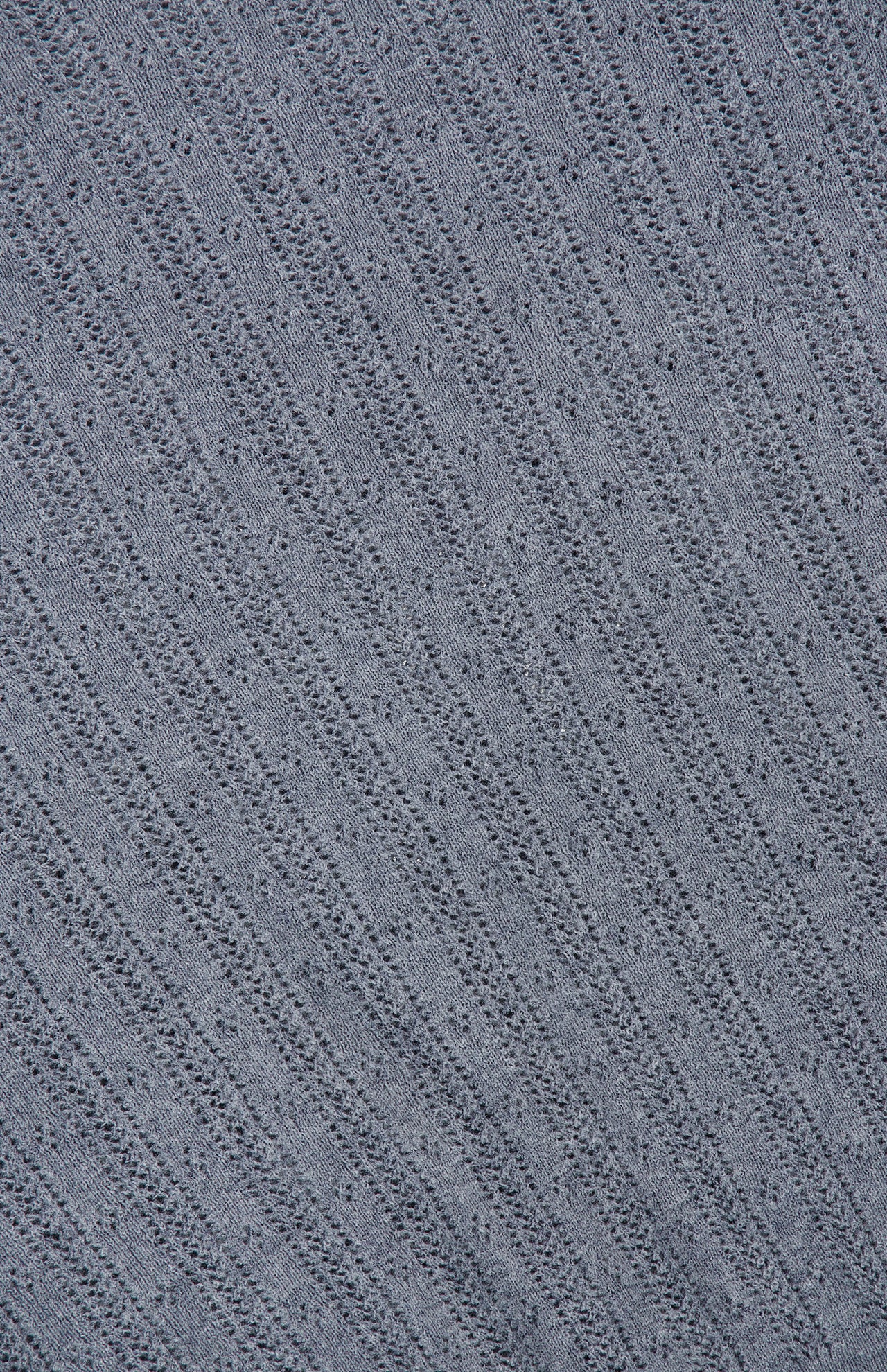 Close-up of the Suyin T-Shirt by LISA YANG, showcasing its grey knit fabric with a diagonal ribbed pattern and small, regular perforations throughout, emphasizing the lightweight cashmere texture.