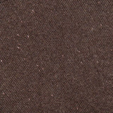 Close-up of the Tarie Sparkle Sweater by LISA YANG, featuring soft brown knit fabric with a ribbed collar accenting the top left corner. The Scandinavian-inspired design highlights its refined texture and scattered lighter specks throughout, embodying the understated elegance of luxury knitwear.