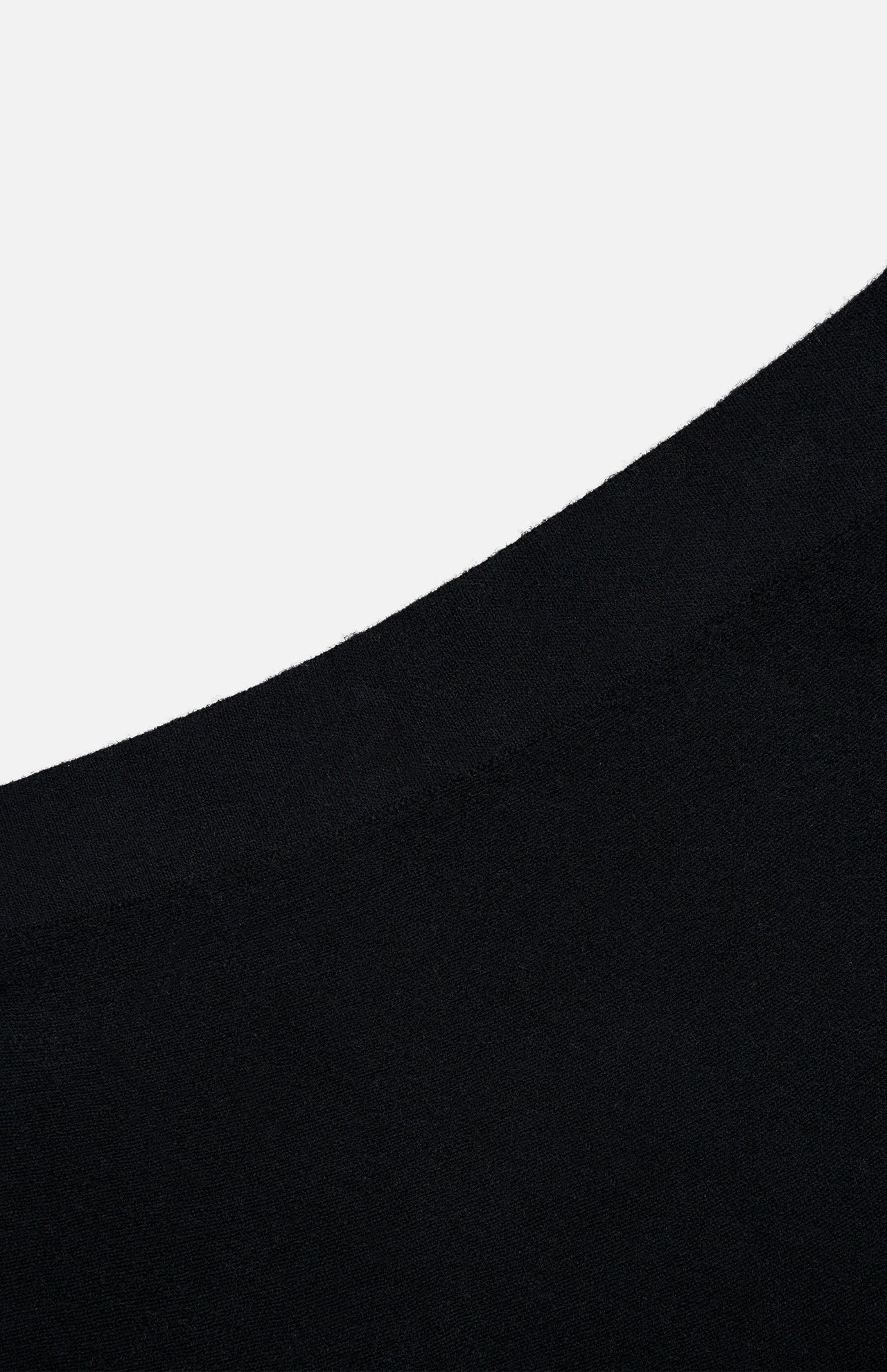 Close-up of the LISA YANG Torie Flared Cashmere Skirt in black, featuring its softly curved hem and the refined texture of luxury knitwear against a plain white background.