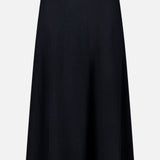 The LISA YANG Torie Flared Cashmere Skirt features a smooth, luxurious knit with an A-line silhouette, an elastic waistband, and a simple knee-length design. Shown against a white background, this elegant black skirt embodies timeless sophistication.