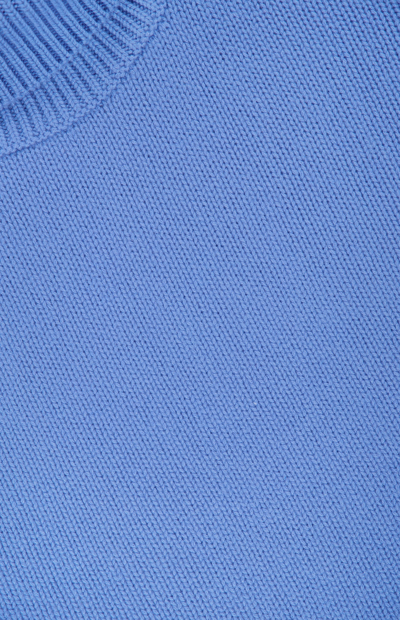 Close-up of the light blue knitted fabric and ribbed collar edge of the Zerlina Turtleneck Sweater by LISA YANG.