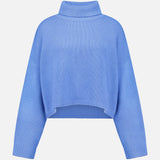 The Zerlina Turtleneck Sweater by LISA YANG is a blue cashmere piece with long sleeves, a high neckline, and a relaxed silhouette. Featuring a cropped hem for contemporary flair, this luxury sweater is displayed on a plain white background.