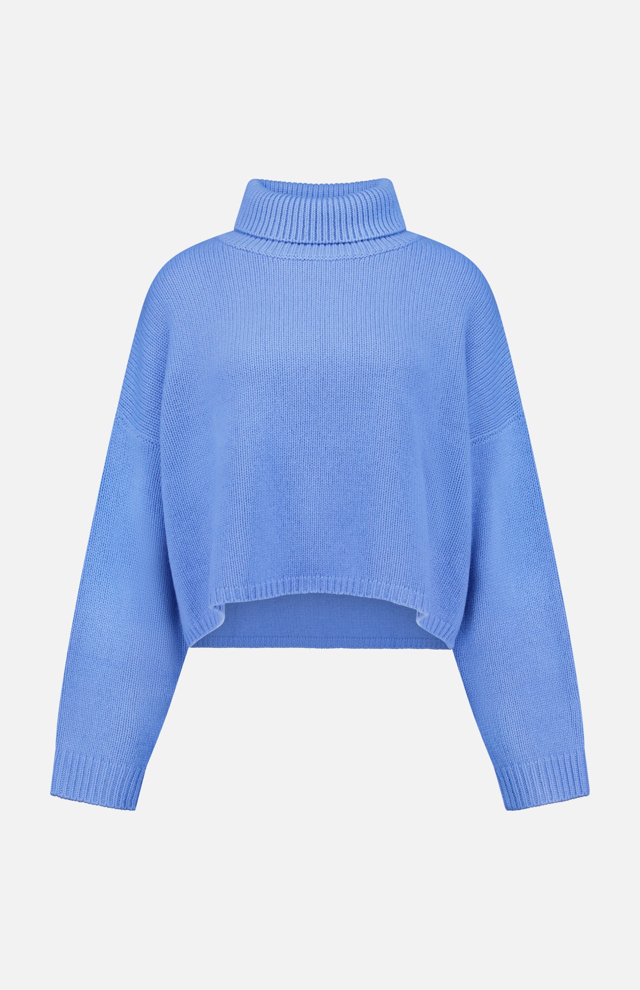 The Zerlina Turtleneck Sweater by LISA YANG is a blue cashmere piece with long sleeves, a high neckline, and a relaxed silhouette. Featuring a cropped hem for contemporary flair, this luxury sweater is displayed on a plain white background.