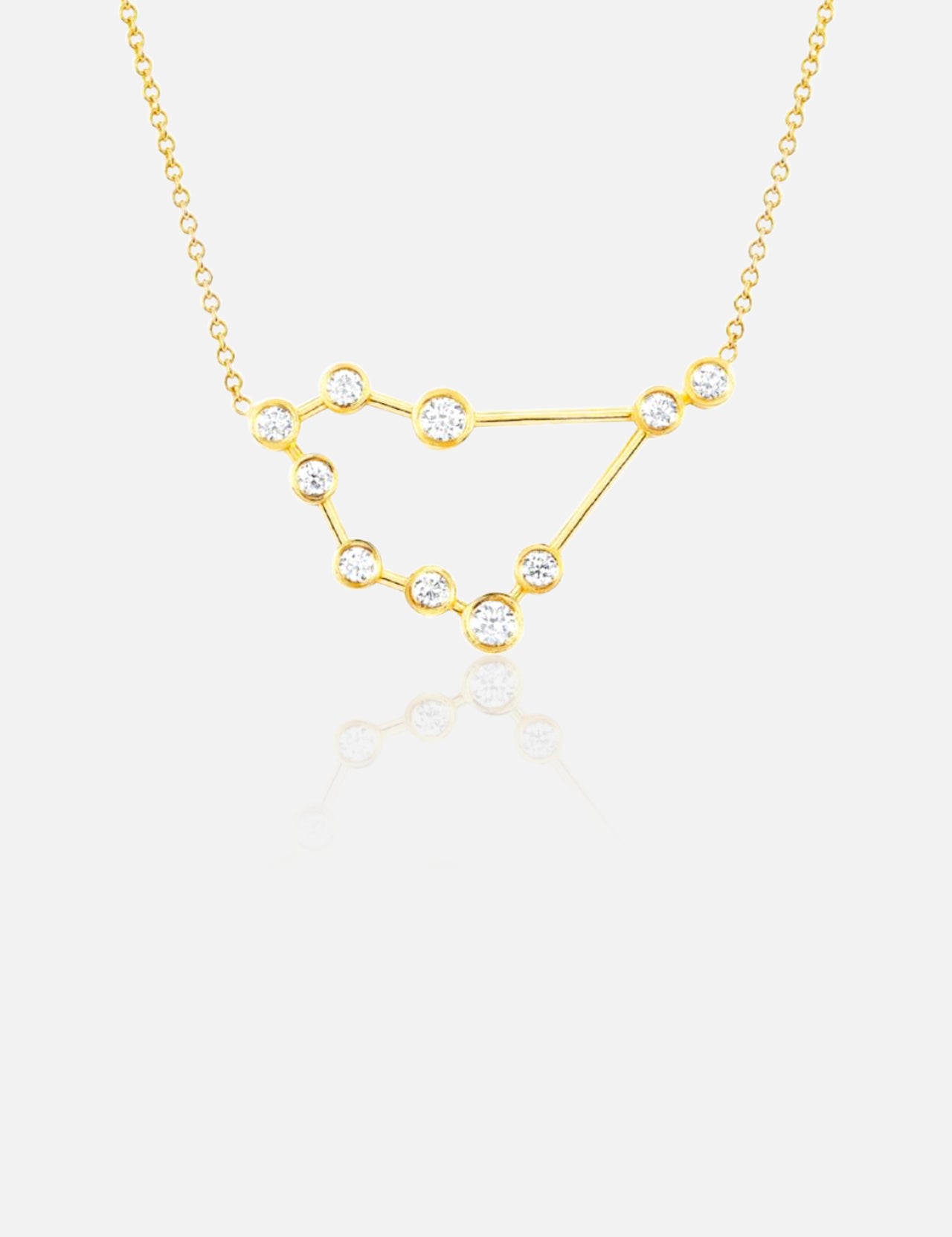 The LOGAN HOLLOWELL Capricorn Constellation Necklace in yellow gold features diamond-accented star points linked by fine gold lines, suspended on a delicate chain and shown against a white background.
