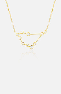 The LOGAN HOLLOWELL Capricorn Constellation Necklace in yellow gold features diamond-accented star points linked by fine gold lines, suspended on a delicate chain and shown against a white background.