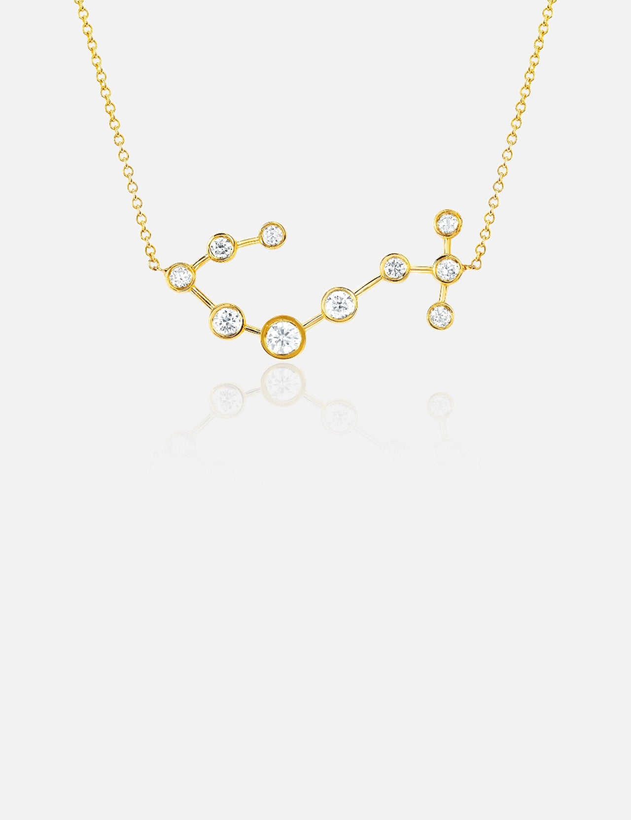 The LOGAN HOLLOWELL Scorpio Diamond Constellation Necklace features a yellow gold pendant with small round diamonds connected by gold links, shown on a white background.