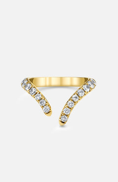 The LOGAN HOLLOWELL French Pave Diamond Tusk Ring is a 14k yellow gold open-front ring with two curved, tusk-like ends, each encrusted with round white diamonds and displayed on a plain light background.