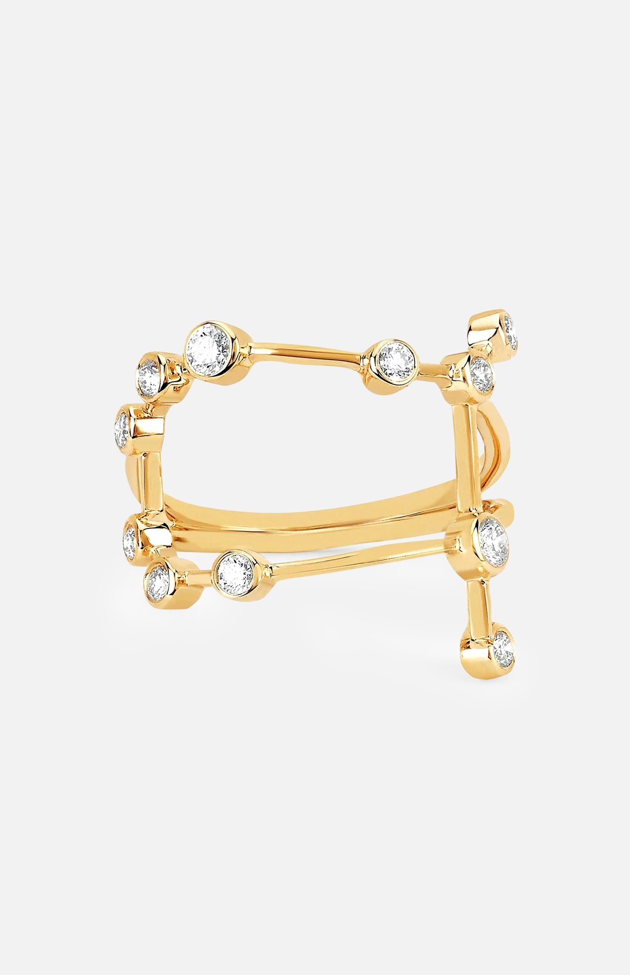The LOGAN HOLLOWELL Gemini Constellation Ring showcases a modern open yellow gold design with two parallel bands linked by vertical bars, embellished with diamond accents and round clear gemstones.