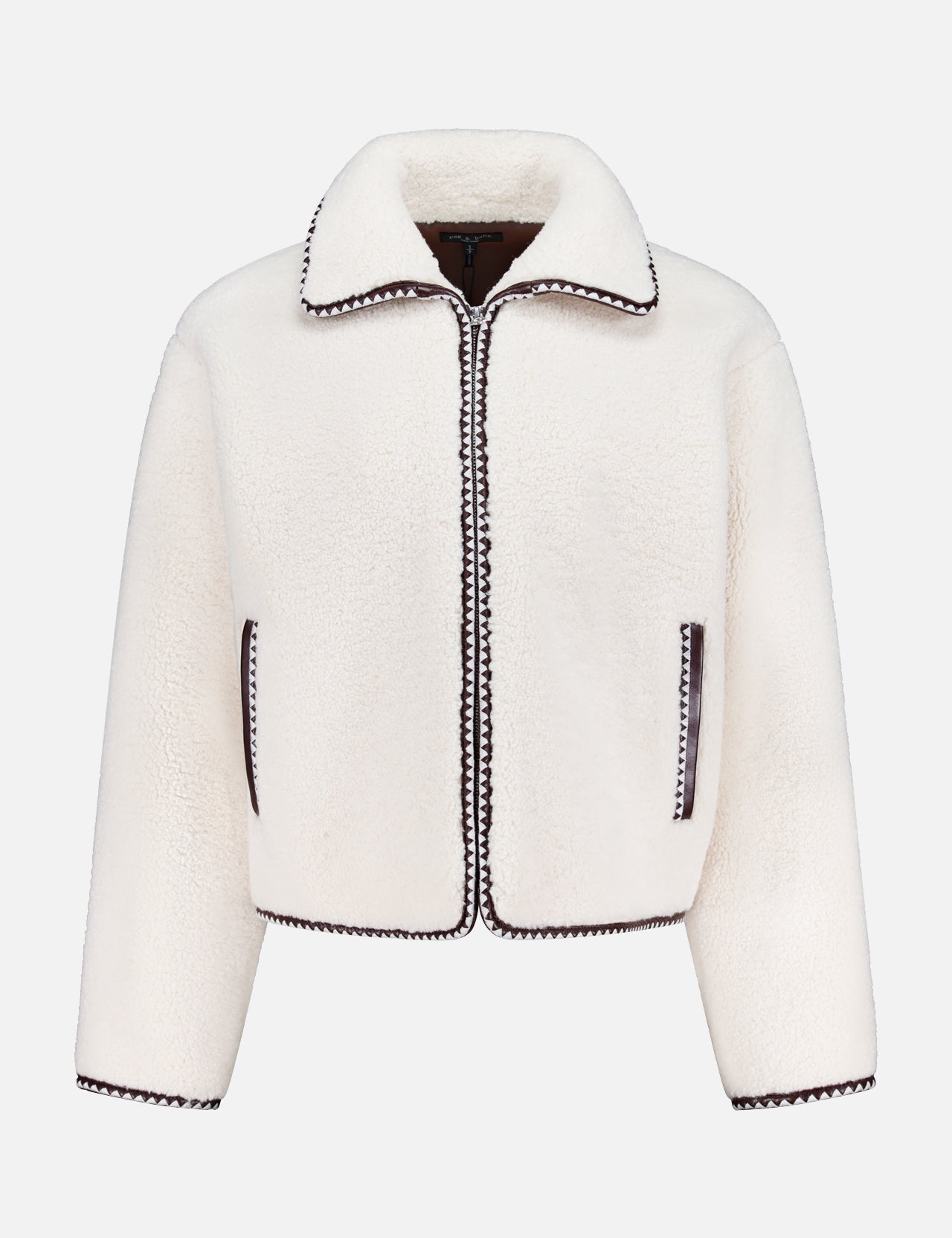 The Mai Sherpa Zip Up Jacket by RAG & BONE is a cozy ivory layer with long sleeves, a collar, zip front, and black trim on the edges, pockets, and hems—stylishly shown against a plain white background.